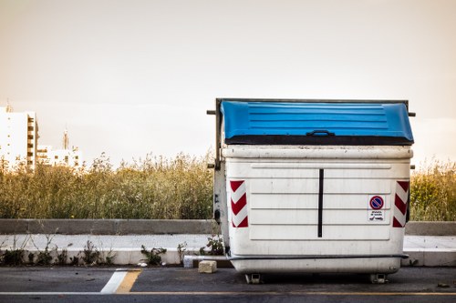 Tottenham skip with recycling symbols and workers sorting materials
