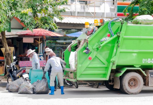Construction site with a skip and workers ensuring safety